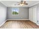 Bright bedroom with wood floors, ceiling fan, and a large window offering natural light and outdoor views at 300 Johnson Ferry Ne Rd # A811, Atlanta, GA 30328