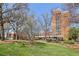 Exterior view of the building with green lawn, trees and sunny sky at 300 Johnson Ferry Ne Rd # A811, Atlanta, GA 30328