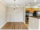 Open floor plan with wood floors and a chandelier; the dining area is adjacent to the updated kitchen at 300 Johnson Ferry Ne Rd # A811, Atlanta, GA 30328