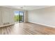 Living room with wood floors, bright light, and sliding glass doors leading to an outdoor balcony at 300 Johnson Ferry Ne Rd # A811, Atlanta, GA 30328