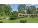 Single-story home with a brick facade, large front yard, and carport at 3563 Carriage Way, East Point, GA 30344