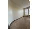 Bedroom view showcasing the carpeted floors, the light fixture, and the window with blinds at 898 Oak St Sw # 1215, Atlanta, GA 30310