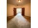 Spacious bedroom showing the neutral wall paint, carpet, and wooden doors at 898 Oak St Sw # 1215, Atlanta, GA 30310