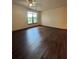 Bright bedroom featuring hard wood floors, a ceiling fan, and a large window at 898 Oak St Sw # 1215, Atlanta, GA 30310