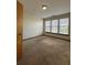 Bedroom view showcasing the carpeted floors, the light fixture, and the window with blinds at 898 Oak St Sw # 1215, Atlanta, GA 30310