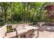 Elevated wooden deck with modern outdoor dining furniture surrounded by lush greenery, ideal for entertaining and enjoying nature at 999 Seaboard Nw Ave, Atlanta, GA 30318