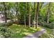 Lush backyard with a winding stone path, mature trees, and well-maintained lawn, creating a serene and private outdoor space at 999 Seaboard Nw Ave, Atlanta, GA 30318