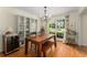 Bright dining room with hardwood floors, a modern chandelier, and a large window at 999 Seaboard Nw Ave, Atlanta, GA 30318