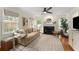 Inviting living room with hardwood floors, a fireplace, and a comfortable seating area at 999 Seaboard Nw Ave, Atlanta, GA 30318