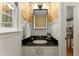 Stylish powder room with a unique wallpaper, black countertop, and modern fixtures at 999 Seaboard Nw Ave, Atlanta, GA 30318