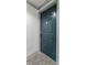A blue door framed with white trim is set against a neutral wall and carpeted floor, offering a clean and simple aesthetic at 1280 W Peachtree Street Nw # 808, Atlanta, GA 30309