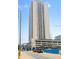 Captured from the street, the image displays a tall condo building with a parking garage and nearby construction at 1280 W Peachtree Street Nw # 808, Atlanta, GA 30309