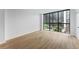 Condo room featuring wood floors and a large window offering expansive city views at 1280 W Peachtree Street Nw # 808, Atlanta, GA 30309