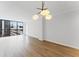 Living room with hardwood floors, a contemporary chandelier, and a wall of windows overlooking the city at 1280 W Peachtree Street Nw # 808, Atlanta, GA 30309