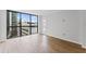 Spacious room with wood floors and a large window offering city views; bright and airy at 1280 W Peachtree Street Nw # 808, Atlanta, GA 30309