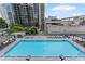 Stunning aerial view of the sparkling swimming pool with lounge chairs and city views, ideal for summer relaxation at 1280 W Peachtree Street Nw # 808, Atlanta, GA 30309