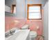 Charming bathroom featuring a classic sink, toilet, and a window for natural light, creating a cozy space at 135 5Th Ave, Jonesboro, GA 30236