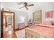 Cozy bedroom with hardwood floors, ceiling fan, and neutral decor at 135 5Th Ave, Jonesboro, GA 30236