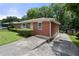 Side view of brick home, showcasing the driveway and landscaping at 135 5Th Ave, Jonesboro, GA 30236