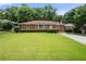 Charming brick home with a well-manicured lawn and mature landscaping at 135 5Th Ave, Jonesboro, GA 30236