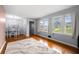 Bright living area featuring hardwood floors and ample natural light from multiple windows at 135 5Th Ave, Jonesboro, GA 30236