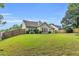 Expansive backyard showcasing lush lawn, partial fence, and the home's rear exterior at 1530 Brisbane Dr, Dacula, GA 30019