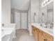 Neutral bathroom with double sink vanity, tile floors, and white trim at 1530 Brisbane Dr, Dacula, GA 30019