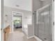 Bright bathroom showcasing shower, tub, double sinks, and tile flooring at 1530 Brisbane Dr, Dacula, GA 30019
