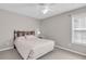 Well-lit bedroom showcasing neutral paint, carpet, and standard closet at 1530 Brisbane Dr, Dacula, GA 30019