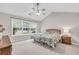 Bright bedroom featuring two twin beds, neutral walls, ceiling fan, and large window at 1530 Brisbane Dr, Dacula, GA 30019
