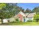 Charming single-Gathering home with a well-manicured lawn, blue door, and a mix of brick and vinyl siding at 1530 Brisbane Dr, Dacula, GA 30019