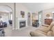 Spacious living room with a fireplace, neutral walls, and comfortable seating, with views into other rooms at 1530 Brisbane Dr, Dacula, GA 30019
