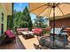 Outdoor patio with shade umbrella and comfy seating overlooking trees at 2822 Prado Ln, Marietta, GA 30066