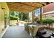 Backyard with a covered patio featuring a hot tub and string lights at 2822 Prado Ln, Marietta, GA 30066