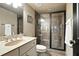 Bathroom featuring a stone counter, framed mirror, and a glass enclosed shower at 2822 Prado Ln, Marietta, GA 30066