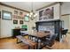 Stylish dining room with wooden table, rustic bench, stone fireplace and unique decorations at 2822 Prado Ln, Marietta, GA 30066