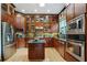 This open kitchen boasts hardwood floors, cherry cabinets, stainless steel appliances, and granite countertops at 2822 Prado Ln, Marietta, GA 30066