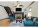 Spacious living area with hardwood floors, stone fireplace, comfortable seating, and open staircase at 2822 Prado Ln, Marietta, GA 30066