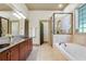 Spacious main bathroom offers a double sink vanity, a soaking tub, and a glass-enclosed shower at 2822 Prado Ln, Marietta, GA 30066