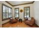Cozy sitting area with hardwood floors, comfortable chairs, and plantation shutters for privacy at 2822 Prado Ln, Marietta, GA 30066