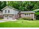 Charming brick home with a two-car garage and well-manicured front lawn at 3409 Shorelake Dr, Tucker, GA 30084
