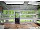 A spacious greenhouse features shelving, brick flooring, and large windows for ample natural light at 3409 Shorelake Dr, Tucker, GA 30084