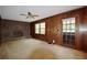 Inviting living room has a brick fireplace, wood paneling, and a glass panel door at 3409 Shorelake Dr, Tucker, GA 30084
