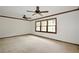 Large, carpeted living room with big windows and ceiling fans offers comfort and ample natural light at 3409 Shorelake Dr, Tucker, GA 30084