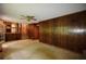 Cozy living room boasts wood paneling, carpeted floor, and ample natural light at 3409 Shorelake Dr, Tucker, GA 30084