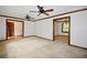 Spacious living room featuring two ceiling fans, neutral carpet, and dark wood trim, ready for personalization at 3409 Shorelake Dr, Tucker, GA 30084