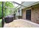 Back patio with grill, brick, and a door to the house at 3409 Shorelake Dr, Tucker, GA 30084