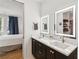 Stylish bathroom with a double vanity featuring modern fixtures, quartz countertops, and a view into the bedroom at , Atlanta, GA 30315