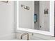 Detail shot of a modern bathroom with an illuminated mirror and contemporary bronze fixtures at , Atlanta, GA 30315