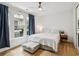 Bright bedroom with a large window, ceiling fan, and hardwood floors creating a cozy and relaxing atmosphere at , Atlanta, GA 30315